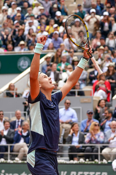 PARIS, FRANCE - MAY 30, 2022: Professional tennis player Holger Rune of Denmark celebrates victory after his round 4 match against Stefanos Tsitsipas of Greece at 2022 Roland Garros in Paris, France