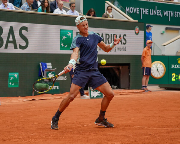 PARIS, FRANCE - MAY 30, 2022: Professional tennis player Holger Rune of Denmark in action during his round 4 match against Stefanos Tsitsipas of Greece at 2022 Roland Garros in Paris, France