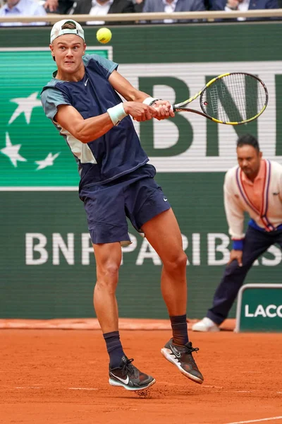 stock image PARIS, FRANCE - MAY 30, 2022: Professional tennis player Holger Rune of Denmark in action during his round 4 match against Stefanos Tsitsipas of Greece at 2022 Roland Garros in Paris, France