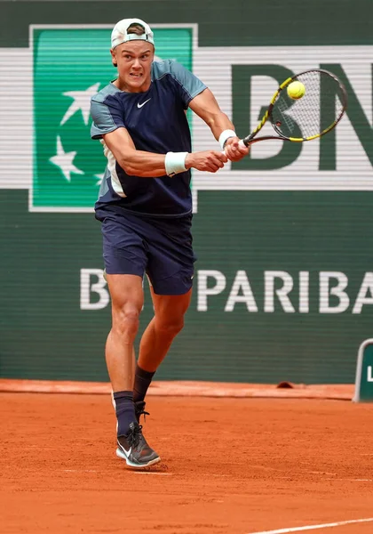 stock image PARIS, FRANCE - MAY 30, 2022: Professional tennis player Holger Rune of Denmark in action during his round 4 match against Stefanos Tsitsipas of Greece at 2022 Roland Garros in Paris, France