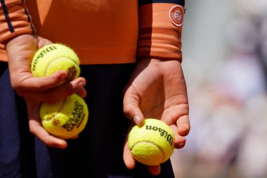 PARIS, FRANCE - MAY 30, 2022: Ball boy holds Wilson Roland Garros tennis ball at Le Stade Roland Garros in Paris, France. Wilson is an Official Partner of the tournament 