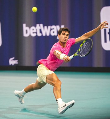 MIAMI GARDENS, FLORIDA - MARCH 30, 2023: Carlos Alcaraz of Spain in action during quarter-final match against Taylor Fritz of United States at 2023 Miami Open at the Hard Rock Stadium in Miami Gardens clipart