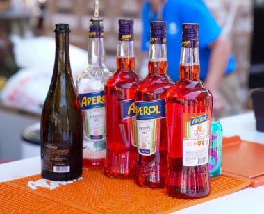 NEW YORK - 3 Eylül 2023: Aperol Aperitivo şişeleri ve Prosecco şişeleri New York 'taki bar masasının üstündeki popüler Aperol Spritz kokteylinin ana malzemeleridir