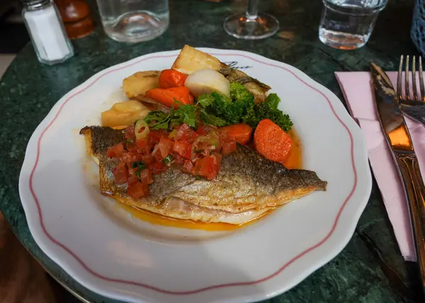 Pan-seared sea bass with French salsa and root vegetables