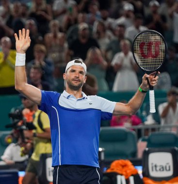 MIAMI GARDENS, FLORIDA - MARCH 28, 2024: Grigor Dimitrov of Bulgaria celebrates victory after quarter-final match against Carlos Alcaraz of Spain at 2024 Miami Open at the Hard Rock Stadium in Miami Gardens clipart