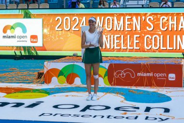 MIAMI GARDENS, FLORIDA - MARCH 30, 2024: 2024 Miami Open Champion Danielle Collins of USA poses with champions trophy after defeating Elena Rybakina of Kazakhstan in the women's singles final match at Hard Rock Stadium in Miami Gardens clipart