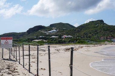 ST. BARTS, FRENCH WEST INDIES - APRIL 18, 2024: Tradewind Aviation Pilatus PC-12s plane taking off at Remy de Haenen Airport also known as Saint Barthelemy Airport. At 2,133 ft its runway is one of the shortest in the world. clipart
