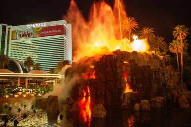 LAS VEGAS, NEVADA - MAY 12, 2014: The Mirage Hotel artificial Volcano Eruption show in Las Vegas, Nevada. The Mirage hotel opened in 1989 and it has 100,000 square feet of gaming space clipart