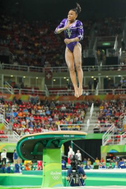 RIO DE JANEIRO, BRAZIL - AUGUST 11, 2016: Brazilian artistic gymnast Rebeca Andrade competes on the vault during a women's artistic gymnastics all-around at Rio 2016 Olympic Games  clipart