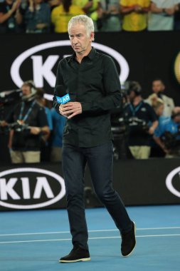 MELBOURNE, AUSTRALIA - JANUARY 22, 2019: Grand slam champion John McEnroe enters Rod Laver Arena for on court  interview during 2019 Australian Open at Australian tennis center in Melbourne clipart