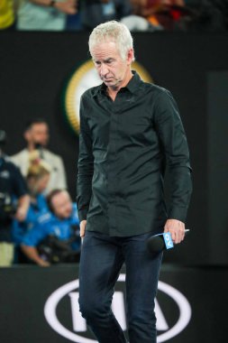 MELBOURNE, AUSTRALIA - JANUARY 22, 2019: Grand slam champion John McEnroe enters Rod Laver Arena for on court  interview during 2019 Australian Open at Australian tennis center in Melbourne clipart