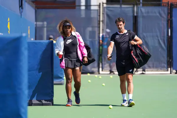 stock image NEW YORK - SEPTEMBER 7, 2019: Grand Slam champion Serena Williams with her coach Patrick Mouratoglou enter practice courts during 2019 US Open at USTA National Tennis Center in New York