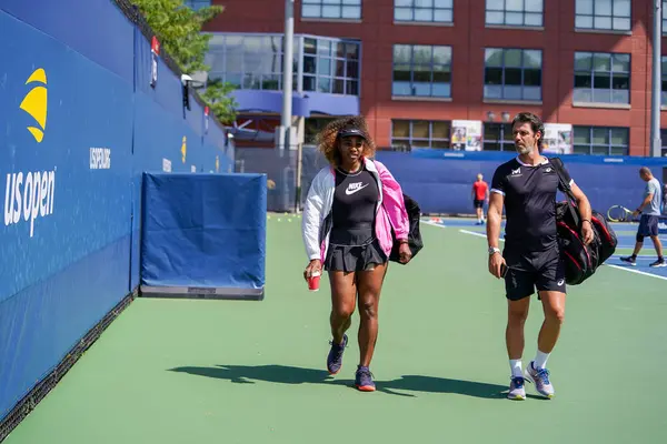 stock image NEW YORK - SEPTEMBER 7, 2019: Grand Slam champion Serena Williams with her coach Patrick Mouratoglou enter practice courts during 2019 US Open at USTA National Tennis Center in New York