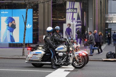 NEW YORK - FEBRUARY 8, 2024: NYPD Highway Patrol officers on motorcycles provide security in Manhattan. New York Police Department, established in 1845, is the largest police force in USA clipart