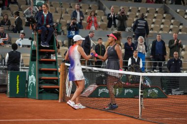 PARIS, FRANCE - MAY 29, 2024: Grand Slam Champions Iga Swiatek of Poland (L) and Naomi Osaka of Japan embrace by the net after 2024 Roland Garros second round match at Court Philippe Chatrier in Paris, France clipart