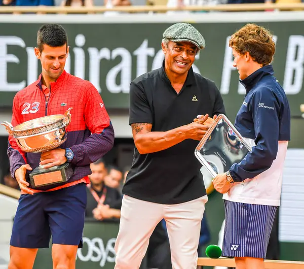 stock image PARIS, FRANCE - JUNE 11, 2023: 2023 Roland Garros Champion Novak Djokovic of Serbia with Yannick Noah during trophy presentation after men singles final match against Casper Ruud of Norway at Court Philippe Chatrier