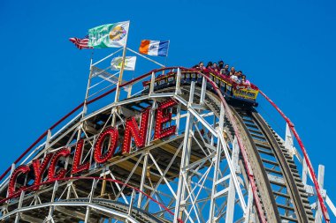 BROOKLYN, NEW YORK - JUNE 20, 2021: Historical landmark Cyclone roller coaster in the Coney Island section of Brooklyn. Cyclone is a historic wooden roller coaster opened on June 26, 1927 clipart