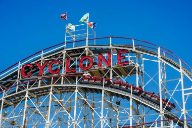 BROOKLYN, NEW YORK - JUNE 20, 2021: Historical landmark Cyclone roller coaster in the Coney Island section of Brooklyn. Cyclone is a historic wooden roller coaster opened on June 26, 1927 clipart