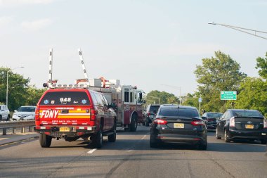 BROOKLYN, NEW YORK - JUNE 20, 2021: Fire Department New York vehicles at the scene after car accident on Belt Parkway in Brooklyn, New York clipart