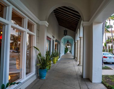 PALM BEACH, FLORIDA - NOVEMBER 14, 2024: Covered walkway on Worth Ave in Palm Beach, Florida. It was designed by Addison Mizner in the 1920s clipart