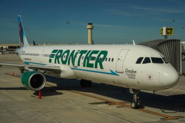 WEST PALM BEACH, FLORIDA - DECEMBER 7, 2021: Frontier Airlines plane on tarmac at Palm Beach International Airport, Florida clipart