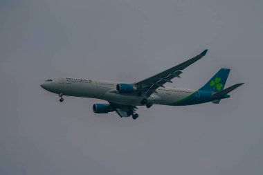 NEW YORK - JULY 25, 2024: Aer Lingus Airbus A330 descending for landing at JFK International Airport in New York. Aer Lingus, is the flag carrier airline of Ireland and the second-largest airline in Ireland clipart