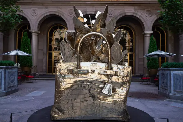 NEW YORK - 20 Haziran 2024: Roman Feral tarafından yapılmış dev, bronz bir Hermes Birkin çanta heykeli Manhattan şehir merkezindeki Lotte New York Palace Hotel 'in avlusunda sergileniyor..