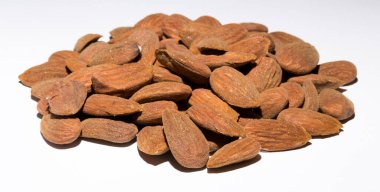 Shelled almonds (Prunus dulcis). A lot of peeled almonds on a white field.