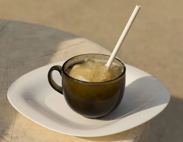 Ice beer. Creative drink. A glass mug with beer and a straw.
