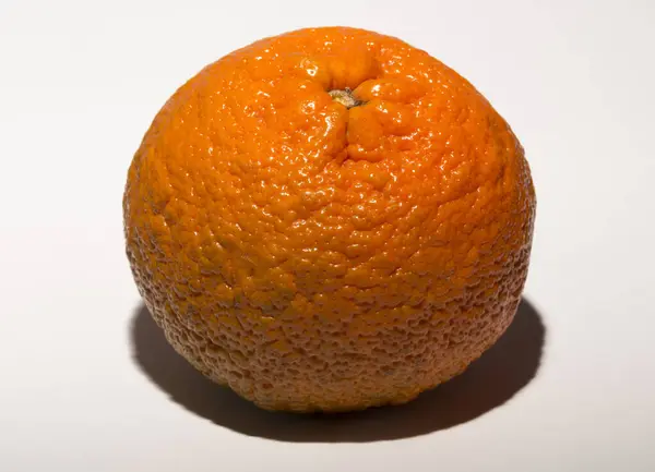 stock image The mandarin orange (Citrus reticulata),mandarine, is a small citrus tree fruit. White background. Association with cellulite skin.
