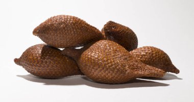 Salak (Salacca zalacca) is a species of palm tree (family Arecaceae), snake fruit or snakeskin fruit due. Several fruits on a white background. clipart