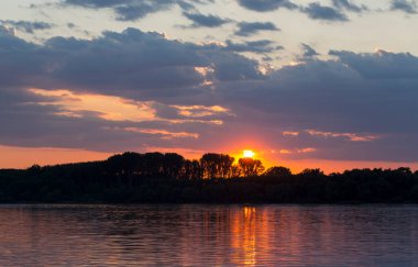 Tuna Nehri 'nde kanlı bir günbatımı. Sudaki manzaranın yansıması..