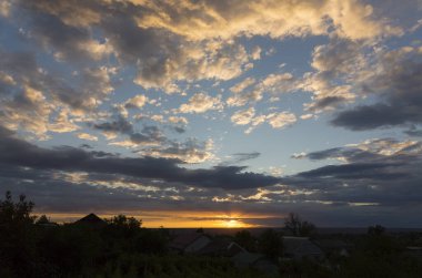 Landscape at sunset. Tragic gloomy sky. Panorama. Crimson twilight.
