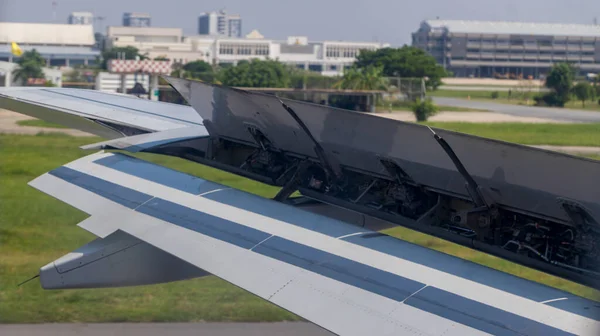 stock image Wing braking of the aircraft on the runway. The wing of an aircraft  open flaps on the wing for is landing. 