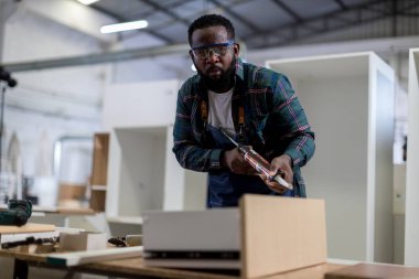 Carpenter working in carpentry shop. Carpenter working to making wood furniture in wood workshop