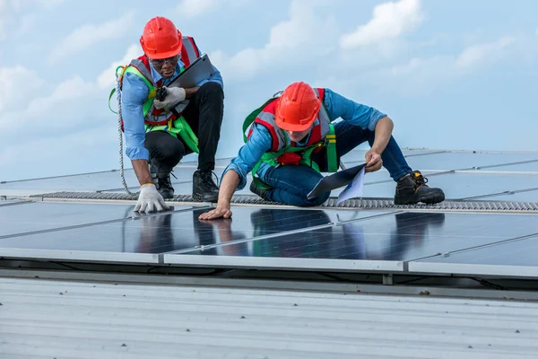 stock image Engineer working setup Solar panel at the roof top. Engineer or worker work on solar panels or solar cells on the roof of business building