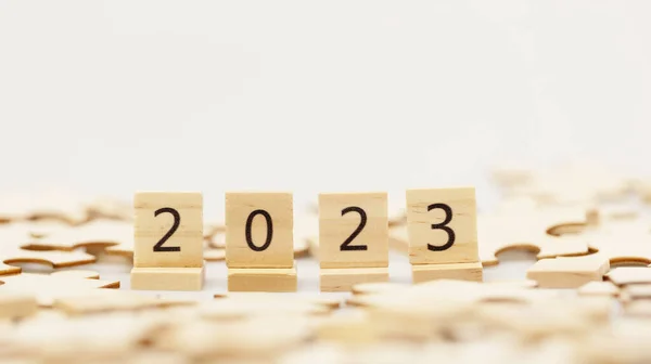 Happy New year 2023 background banner. Two thousand Twenty-Three year numbers on wooden blocks stack. wood blocks or square with number 2023
