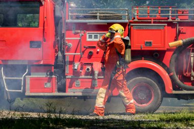 Fireman with equipment in a fully protective suit