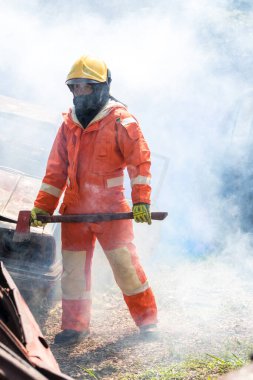Fireman with equipment in a fully protective suit