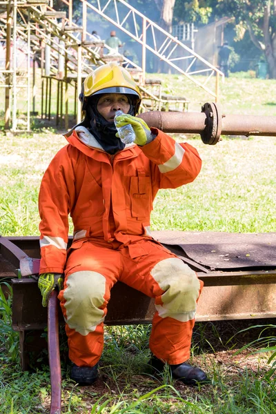 Fireman rest and drinking water in work site.