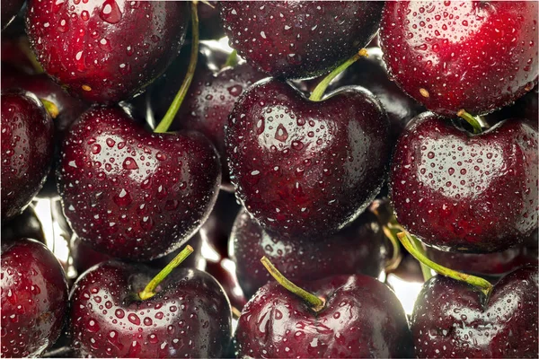 Cherry background. Sour cherry. Ripe cherries with stalks. Wet cherry with stalks and drops.