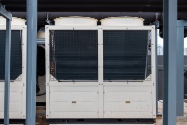 Air conditioner compressor installed on roof building. Industrial air conditioning units. Industrial air conditioning and ventilation systems on roof. Cooling towers in data center building.