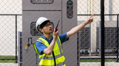 Electrical engineer working in Site. Electrical engineer man checking Power Distribution Cabinet 