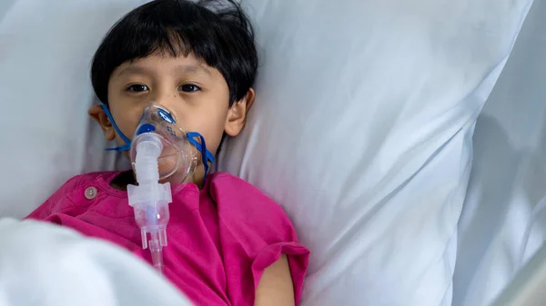 stock image Sick boy inhalation therapy by the mask of inhaler. Baby has asthma and need nebulizations. Patient Boy use inhalation with Nebulizer mask at hospital. The baby are spraying bronchodilators .