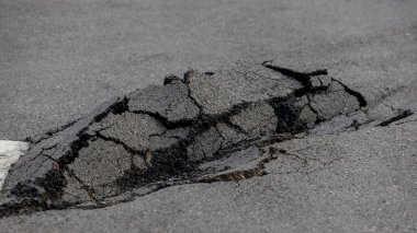 Asphalt road damaged. cracked road after earthquake. Poor asphalt surface.