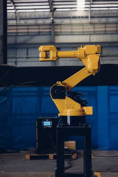 New Generation Robotic Arm Ready for Work on a Production Line. New robot arm for the production line of industrial factory. Robot arm manipulator at the factory. Industrial automation technology.