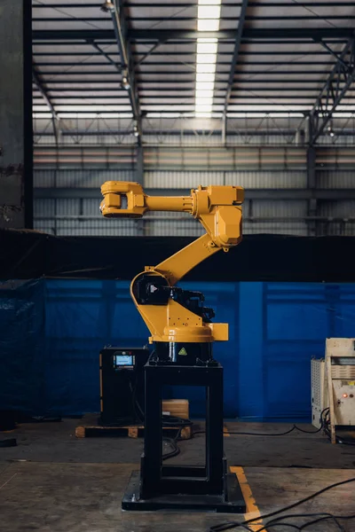 New Generation Robotic Arm Ready for Work on a Production Line. New robot arm for the production line of industrial factory. Robot arm manipulator at the factory. Industrial automation technology.
