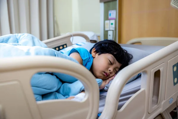 Children sick sleeping on the bed at the hospital. Sick little boy with asthma medicine. Little child sleeping in hospital bed