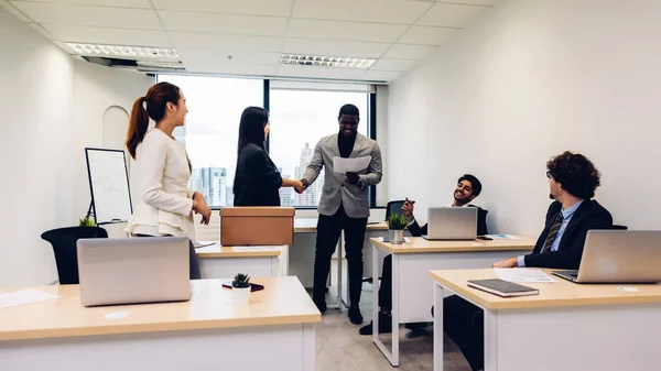 Welcome to new office. Friendly welcoming new employee introducing hired worker in multiracial office . Welcoming New employee team member on first work day, introduction concept