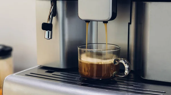 self-service coffee machines offer consistent, quality coffee in hotel, sport club or office. Espresso cappuccino coffee machine on the table. Espresso coffee pouring from espresso machine. Barista